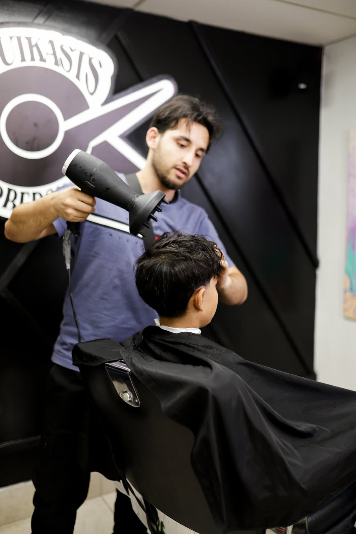 Elham, barber at OutKasts Barbershop