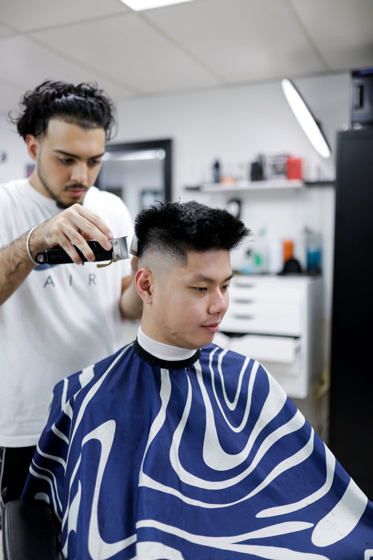 Eraj, barber at OutKasts Barbershop